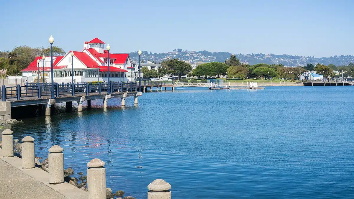 Richmond Marina Bay waterfront with red-roofed Ferry Point building and San Francisco Bay views representing property management in Richmond CA by All East Bay Properties